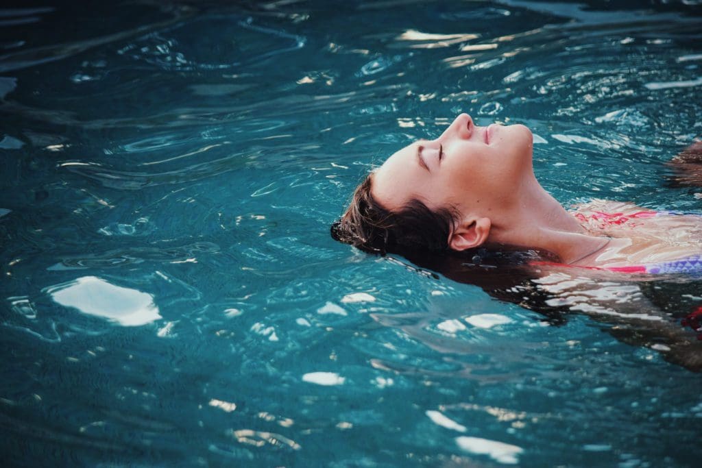woman floating on back in water