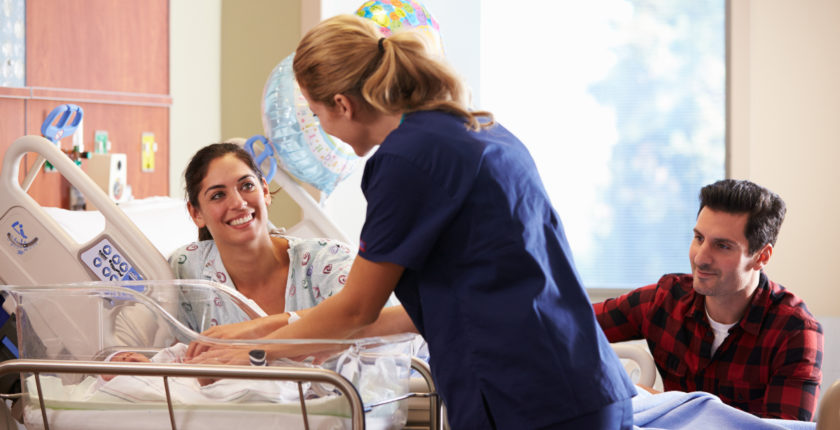 A labor and delivery nurse attends to a baby. Delivery nurses are one of the best travel nursing specialties in 2019.